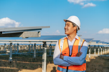 Asian Young engineer standing at solar farm