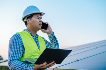 Young engineer use smartphone while working at solar farm