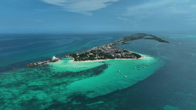 Aerial view of boats in turquoise waters, on the coast of Isla Mujeres, Mexico - approaching, drone shot