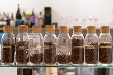 Rows of jars of coffee beans at the coffee bar. Coffee shop concept