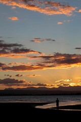 Fototapeta premium Vertical of a sunset over the beach in Nelson, New Zealand.