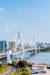 Naklejka premium High view sunny day scenery of Century Bridge on Haidian River, Haikou, Hainan, China