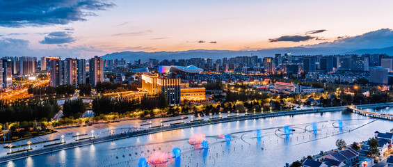 Fototapeta premium Night view of fountain in Ruyi Square, Hohhot, Inner Mongolia, China