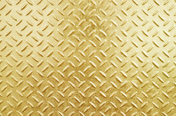 Gold metal plate with embossed pattern for anti slip. Glossy gold grunge metallic textured background.
