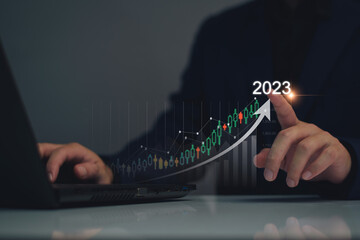 Digital marketing 2023 goals. Businessman analyzing internet marketing online, 2023 business planning, business skyrocket, online stock market analysis, stock chart next year, digital stock trading