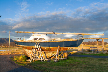 Old boat as art piece yard decoration on farm