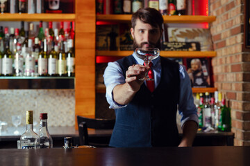 Barman checking the cleanliness of glass