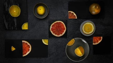 Wandcirkels aluminium View of cutted different citrus fruits in gray background © Anastasija Grinuka/Wirestock Creators