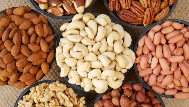 Different nuts in vases on the table.