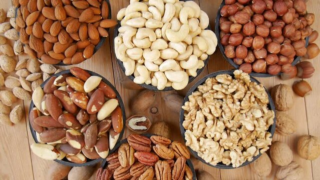 Different nuts in vases on the table.