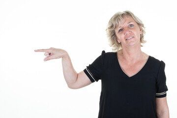 Portrait senior woman casual wear pointing fingers aside isolated over white background