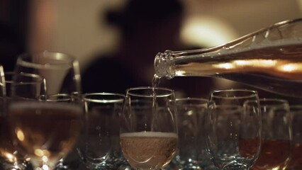 Pouring rose wine to the glass at the wedding event
