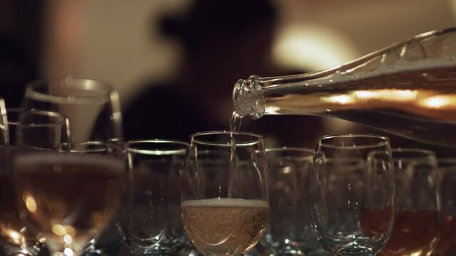 Pouring rose wine to the glass at the wedding event