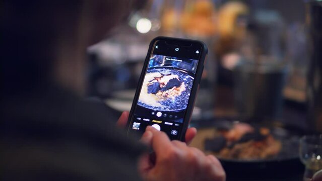 Taking a picture with smartphone of the food in the restaurant