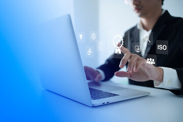ISO Certification of standards quality control assurance business technology concept. Businessman touching virtual screen iso certification icon to guarantee.