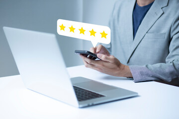 Satisfaction and customer service survey concept, businessman using  smartphone. to answer the questionnaire And the satisfaction rating, the satisfaction rating with the icon 5 stars.