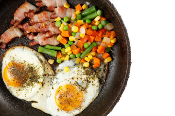 Fried eggs with vegetables in a pan isolate. place for text cope space