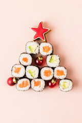 Sushi roll isolated on soft pink background.