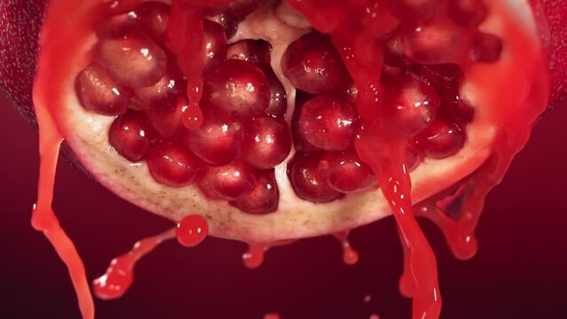 Slow Motion of Flowing Pomegranate Juice from Half Pomegranate