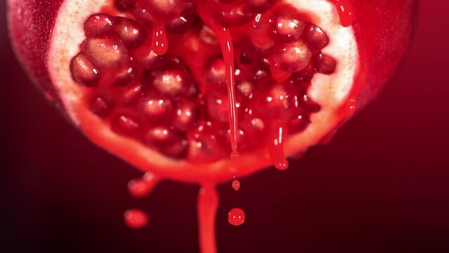 Slow Motion of Flowing Pomegranate Juice from Half Pomegranate