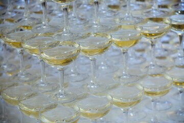 Crystal glasses for holiday, a lot of glasses for guests. Slide pyramid of glasses.
