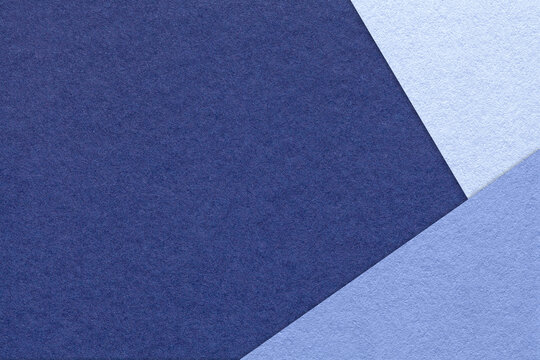 Texture of craft indigo color paper background with denim and very peri border. Vintage abstract navy blue cardboard.