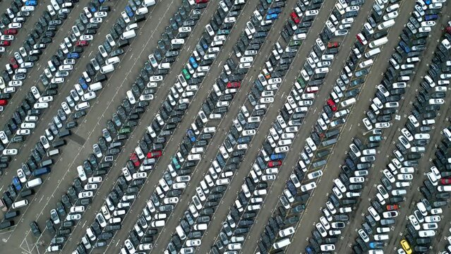 Many cars on a parking lot from above, filmed with a drone in 4k. high quality, thousand's of cars from top