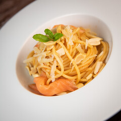 Recipe for homemade spaghetti with tomato sauce, smoked salmon, roasted peanuts and parmesan. High quality photo