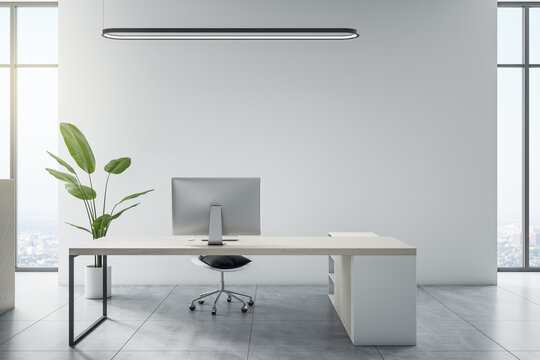 Front view on minimalistic style work place in sunlit light office with white wall, city view from the window and light grey floor. 3D rendering