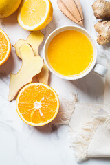 Ginger orange drink in white mug. Winter vitamin beverage for immunity boosting.