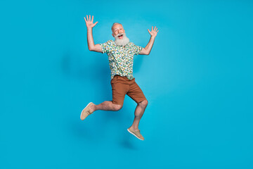 Full size portrait of energetic carefree person jumping have fun isolated on blue color background