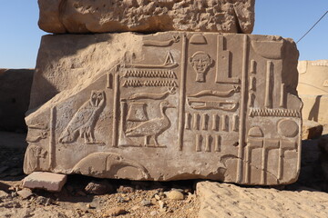Ancient egyptian symbols and hieroglyphics carved at Satet temple in Aswan 