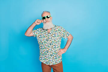 Portrait photo of old age pensioner touch his mustache long gray beard sunglass vacation travel weekend empty space isolated on blue color background