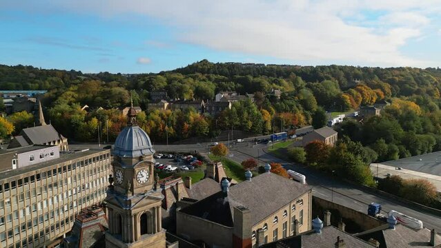 Aerial footage of the market town centre of Dewsbury in West Yorkshire in the UK showing the historical town centre, busy roads and townhall.