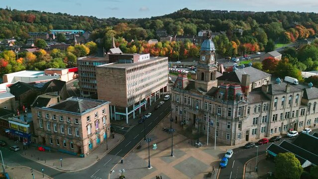 Aerial drone video footage of the market town centre of Dewsbury in West Yorkshire in the UK showing the historical town centre and townhall.