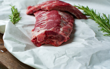 Raw meat on white paper. Close up. Selective focus.