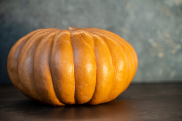 big orange pumpkin on table in the dark halloween concept 