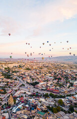 beautiful vertical shot of spectacular Cappadocia and numerous air balloons in the sky. High quality photo