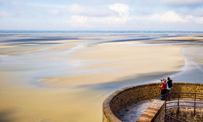 Tourist couple admiring the  scenic view from Le Mont Saint-Michel