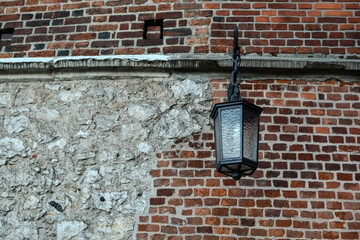 vintage street lamp on the wall of an old house. Beautiful luxury light decor for street lighting