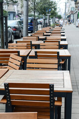 Tables and chairs in cafes or restaurants on the street. Empty decor of wooden tables and chairs in restaurant interior