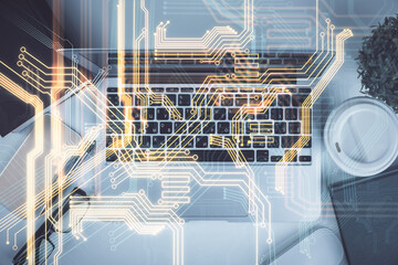 Technology hologram drawing over computer on the desktop background. Top view. Double exposure. Tech concept.