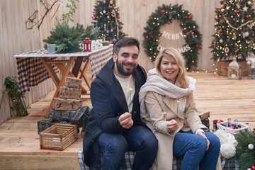 Winter holidays and celebrations. Christmas couple in love near Christmas tree outdoors