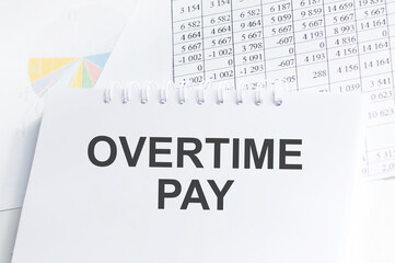 Financial concept about OVERTIME PAY with sign on the sheet.