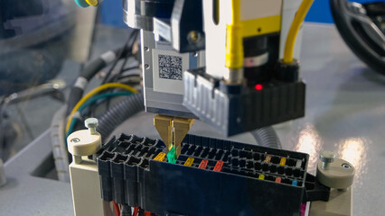 Close-up automatic manufacture robot pulling out a chip. Industrial manufacturing concept. Pull out and insert.