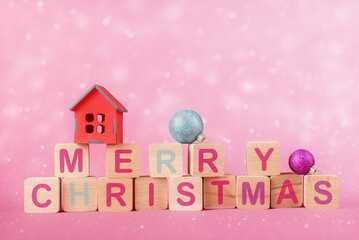 Wooden cubes with caption Merry Christmas and Xmas decoration over abstract holiday background