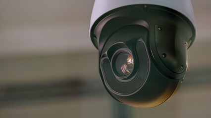 Close-up of surveillance video camera rotating around. Security and safety. - obrazy, fototapety, plakaty