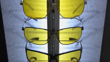 Set of stylish yellow and black sunglasses. Spectacles accessories close-up.