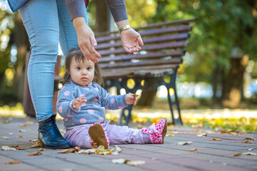 Baby Girl Setting down in the park and lifting your hands to be lifted