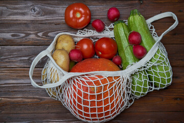 Healthy food vegetables in Eco-friendly packaging reusable bag on wooden table background.